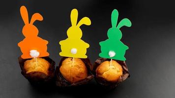 muffin versierd met een papieren konijn op een tandenstoker. Pasen decor foto