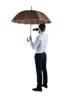 zakenman Hoes zichzelf met een paraplu en horloges ver met een verrekijker foto