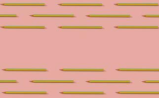 terug naar school. creatief patroon samenstelling van geel en blauw potloden Aan pastel roze achtergrond. minimalistische terug naar school- concept. modieus potloden patroon achtergrond. kopiëren ruimte voor tekst. foto