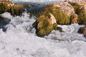 een rivier- met rotsen en water vloeiende over- hen foto