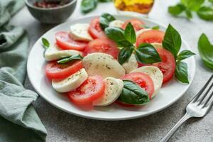 caprese salade met tomaten, mozzarella en basilicum. foto