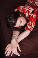 ontspannen vrouw liggend op een bruin bed foto