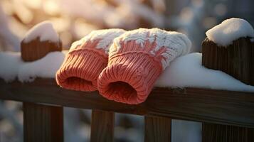 ai generatief wanten, sneeuw handschoenen in de sneeuw in vroeg ochtend- zonlicht foto