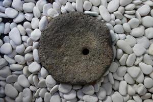 vintage donkere rots omgeven door witte ronde steen. foto