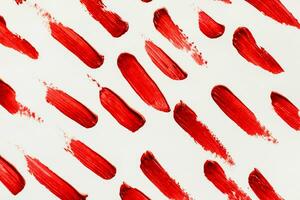 uitstrijkjes van rood kunstmatig lippenstift Aan een licht achtergrond foto