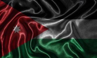 behang met de vlag van Jordanië en wapperende vlag per stof. foto