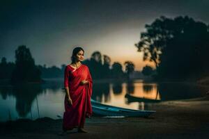 een vrouw in een rood sari staat door de water Bij zonsondergang. ai-gegenereerd foto