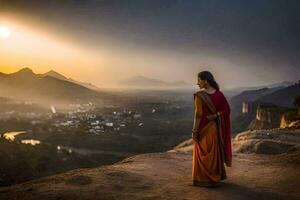 een vrouw in een oranje sari staat Aan een heuvel met uitzicht een vallei. ai-gegenereerd foto