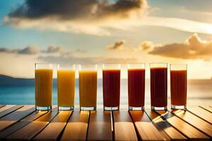 vijf bril van oranje sap Aan een tafel in voorkant van de oceaan. ai-gegenereerd foto