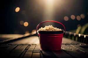 een emmer van popcorn Aan een tafel in voorkant van een licht. ai-gegenereerd foto