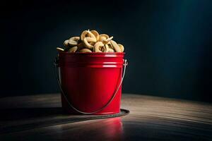 een rood emmer gevulde met een bundel van chips. ai-gegenereerd foto