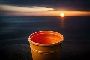 een oranje emmer zittend Aan de strand Bij zonsondergang. ai-gegenereerd foto