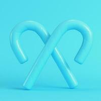 twee gekruiste snoep riet helder blauw achtergrond in pastel kleuren. minimalisme concept foto