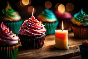 kleurrijk cupcakes met kaarsen Aan een tafel. ai-gegenereerd foto