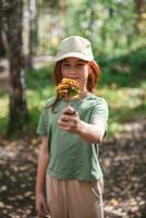 schattig meisje Holding herfst geel bladeren Aan een plank in voorkant van haar foto