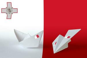 Malta vlag afgebeeld Aan papier origami vliegtuig en boot. handgemaakt kunsten concept foto