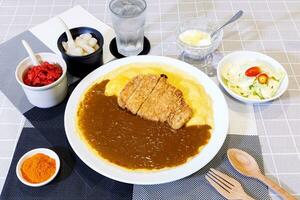 kerrierijst met tonkatsu gebakken varkenskotelet en romige omelet - japanse voedselstijl foto
