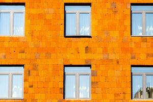 voorkant visie van stedelijk huis betegeld met oranje tegels foto