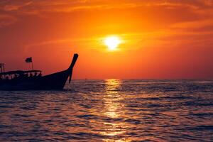 visvangst boot met zonsondergang in phi phi eilanden, Thailand foto