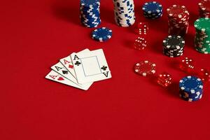 casino het gokken poker uitrusting en vermaak concept - dichtbij omhoog van spelen kaarten en chips Bij rood achtergrond. vier van een soort foto