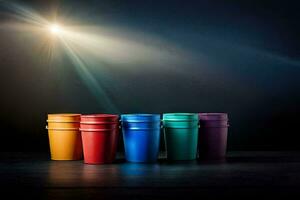 kleurrijk cups Aan een donker tafel met een helder licht schijnend omlaag. ai-gegenereerd foto