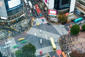 antenne visie van voetgangers wandelen aan de overkant met druk verkeer Bij Shibuya kruispunt foto