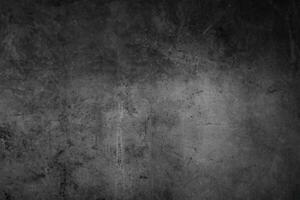textuur van oude grijze betonnen muur voor donkere achtergrond foto