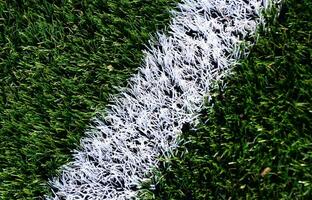 wit streep Aan een helder groen kunstmatig gras voetbal veld- foto