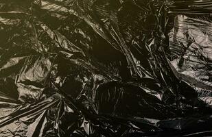 structuur van zwart plastic vuilnis beschikbaar zak foto