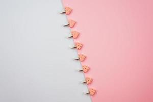 wasknijpers met hartjes op een wit roze achtergrond. feestelijk concept in minimalistische stijl voor Valentijnsdag of een ander liefdesevenement. foto