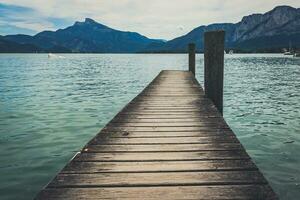 kalmte meer van mondsee in Oostenrijk, visie van de houten pier foto