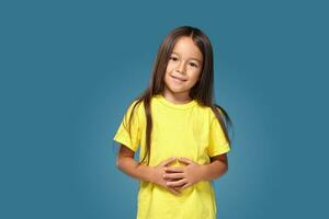 weinig meisje in geel t-shirt is glimlachen foto