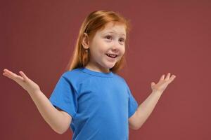 portret van schattig roodharige emotioneel weinig meisje Aan rood achtergrond foto