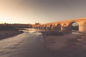 nacht visie van mezquita-kathedraal en puente romano - moskee-kathedraal en de Romeins brug in Cordoba, Andalusië, Spanje foto