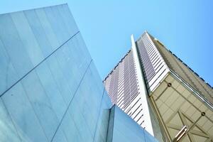 structureel glas muur reflecterend blauw lucht. abstract modern architectuur fragment foto