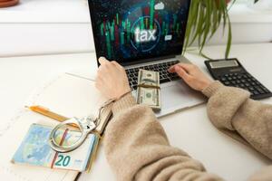 een vrouw met handboeien en een laptop pays belastingen foto