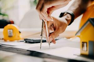 architect Mens werken met laptop en blauwdrukken, ingenieur inspectie in werkplaats voor bouwkundig plannen, schetsen een bouw project ,selectief focus, zaken concept wijnoogst kleur foto