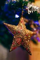 goud ster Aan Kerstmis boom, decoratie en ornament, viering geest foto