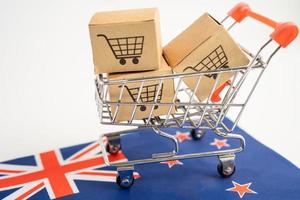 doos met winkelwagenlogo en vlag van Nieuw-Zeeland, import export winkelen online of e-commerce financiën bezorgservice winkel product verzending, handel, leveranciersconcept