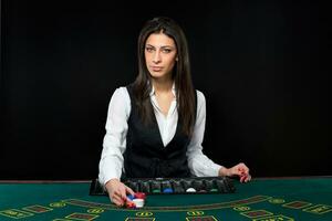 de mooi meisje, handelaar, achter een tafel voor poker foto