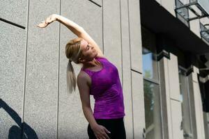 geschiktheid sport vrouw in mode sportkleding aan het doen yoga geschiktheid oefening in de straat, buitenshuis sport, stedelijk stijl foto