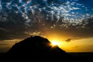 cloudscape zonsondergang lucht met silhouetten van heuvel. foto