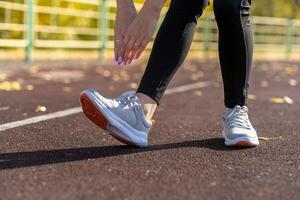 een jong mooi vrouw in sportkleding Toneelstukken sport- Bij een lokaal stadion foto