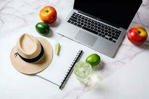 ai gegenereerd top visie van een laptop, hoed, en fruit Aan een marmeren tafel foto