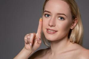 jong vrouw Holding contact lens Aan inhoudsopgave vinger met kopiëren ruimte. dichtbij omhoog gezicht van gezond mooi vrouw over naar slijtage contact lens. foto