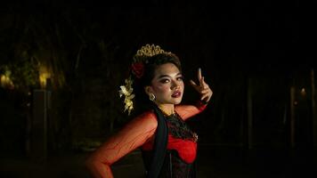 een Indonesisch danser met sprankelend stadium lichten dat creëren de indruk van luxe en elegantie foto