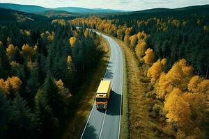 ai gegenereerd arial visie van zwaar vrachtauto Aan een versmallen draaien weg. herfst kleurrijk bomen door de zijden van de weg. foto