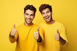 ai gegenereerd portret van een twee gelukkig jong mannen tonen duimen omhoog geïsoleerd over- geel achtergrond foto