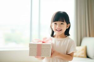 ai gegenereerd schattig Aziatisch weinig meisje Holding geschenk doos in leven kamer foto