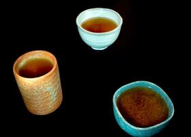thee in keramische beker op zwarte achtergrond foto